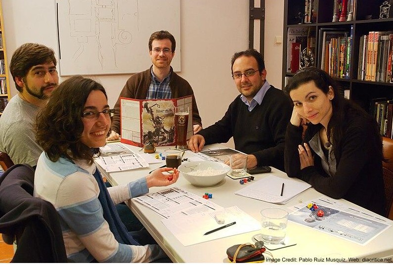 Group of people playing a tabletop game.